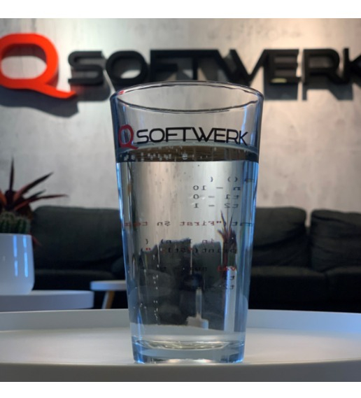 Ett stort glas med vatten där logotypen för Softwerk syns på både glaset och väggen bakom. 